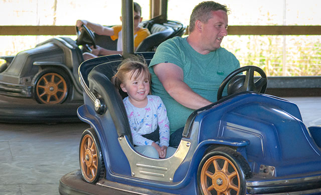 Man with young girl on dodgems
