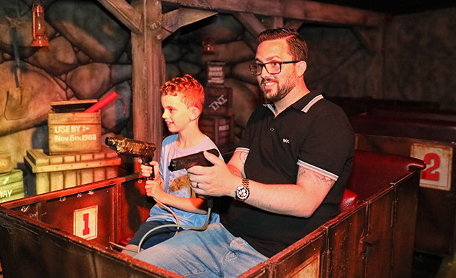 Man and young boy on amusement ride