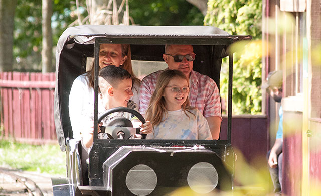 Family on vintage car ride