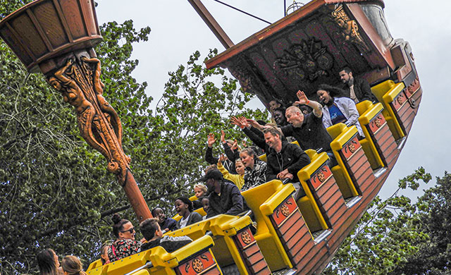 People on pirate ship theme park ride