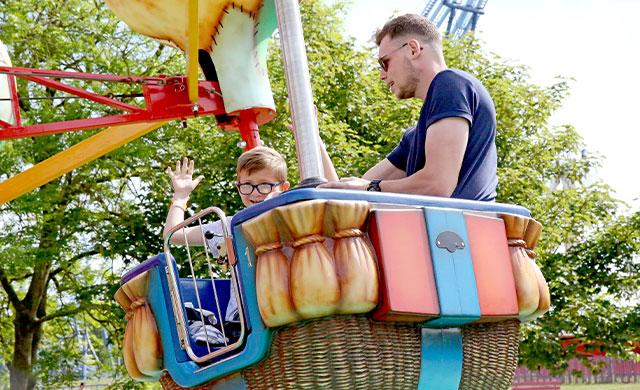 Man and young boy on theme park ride