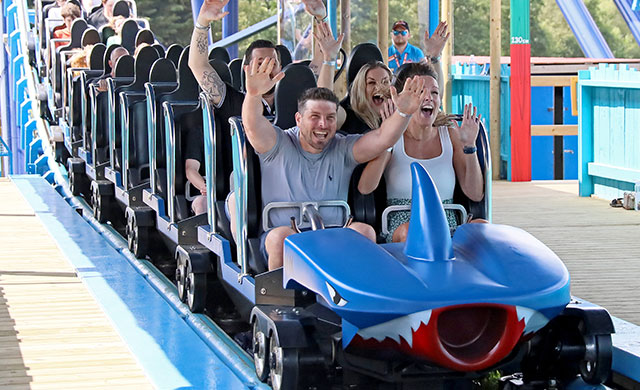 blue rollercoaster with people having fun